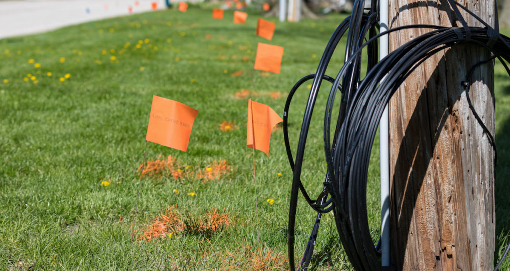 a communications pole marked to be outfitted with fiber cable